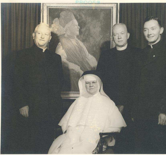 Father Joseph Barry, Mother Mary Gerald Barry, Monsignor William Barry, and Father Joseph Barry in front of a portrait of Bishop Patrick Barry